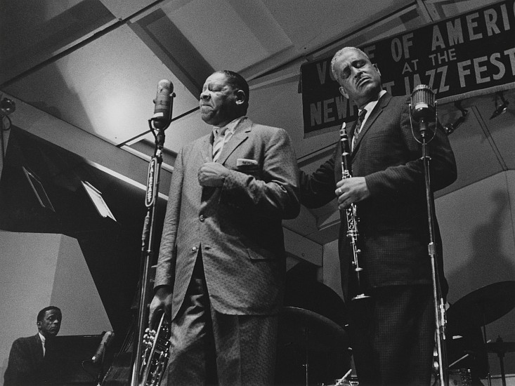 Paul J. Hoeffler, Henry "Red" Allen and Buster Bailey, at Newport Jazz Festival, 1957
Gelatin silver print; printed later, 11 x 14 in. (27.9 x 35.6 cm)
Henry "Red" Allen (1908-1967) was a trumpeter and vocalist, whose style fully incorporated the innovations of Louis Armstrong. Buster Bailey (1902-1967) was a clarinetist (educated by Franz Schoepp, who taught Benny Goodman). Bailey began with W.C. Handy's Orchestra in 1917. In 1965 he joined his old friend Louis Armstrong and became a member of his All-Stars. Signed by the photographer.
7388
$300