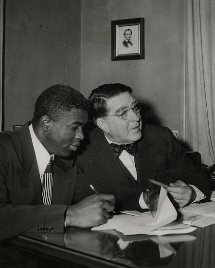 Unidentified photographer, Jackie Robinson signs his contract, January 24, 1950
Vintage gelatin silver print, 9 1/2 x 7 5/8 in. (24.1 x 19.4 cm)
Typed caption affixed to print verso with pencil notations and Keystone Pictures Inc. stamp on print verso.
8482