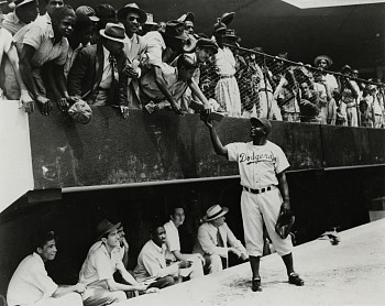Work:&nbsp;Jackie Robinson returns an autograph to a fan in the stands. Dodgers' spring training in Cuidad Trujillo (now Santo Domingo), Dominican Republic