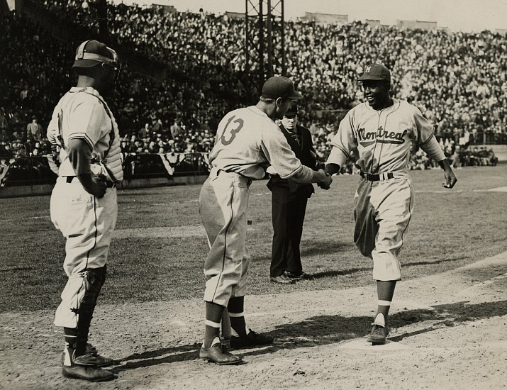 Frank Jurkoski, Shuba shakes hands with Robinson after his first home run, April 18, 1946
Vintage gelatin silver print, 6 1/16 x 7 7/8 in. (15.4 x 20 cm)
With original caption typed on paper 4 x 6 3/16 in.
"S-1039715-WATCH YOUR CREDIT..INTERNATIONAL NEWS PHOTO/ SLUG..(ROBINSON SCORES)/ ROBINSON HOMERS IN AAA LEAGUE DEBUT/ JERSEY CITY, N.J....JACKIE ROBINSON, NEGRO SECOND/ BASEMAN WHO MADE HIS AAA LEAGUE DEBUT WITH THE MONTREAL/ ROYALS, TODAY IS SHOWN BEING CONGRATULATED BY THE NEXT/ BATTER, SHUBA, AFTER SMASHING A THREE RUN HOMER IN THE/ THIRD INNING AGAINST THE JERSEY CITY GIANTS AT ROOSEVELT STADIUM, ROCKLEY AND DE FORGE SCORED AHEAD OF ROBINSON/ ON THE CIRCUT CLOUT. MONTREAL WON 14-1./ B-4-18-46 PHOTO BY FRANK JURKOSKI NY R"
8475
